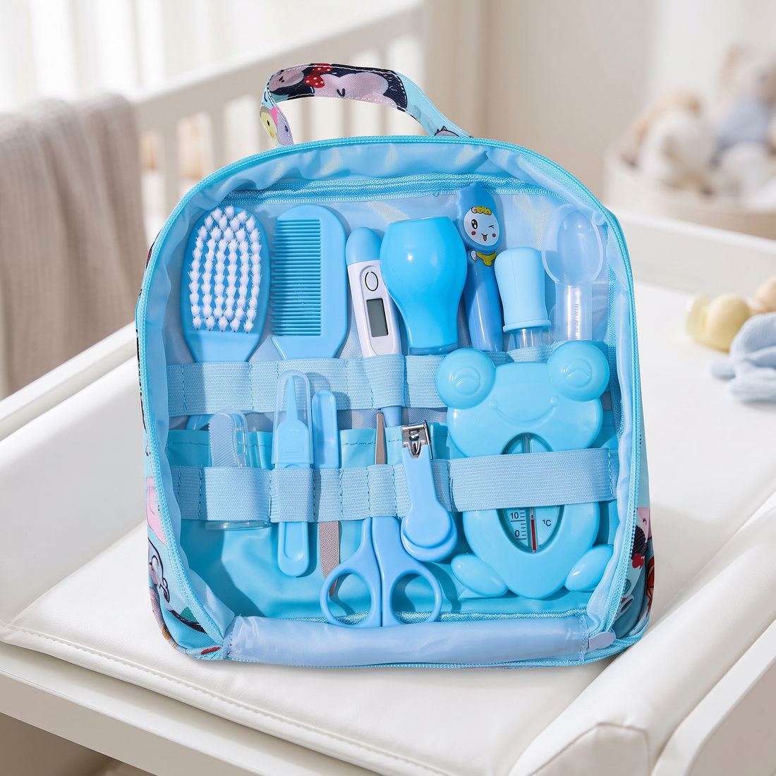 Baby Healthcare and Grooming Kit in its zip bag on a white changing table
